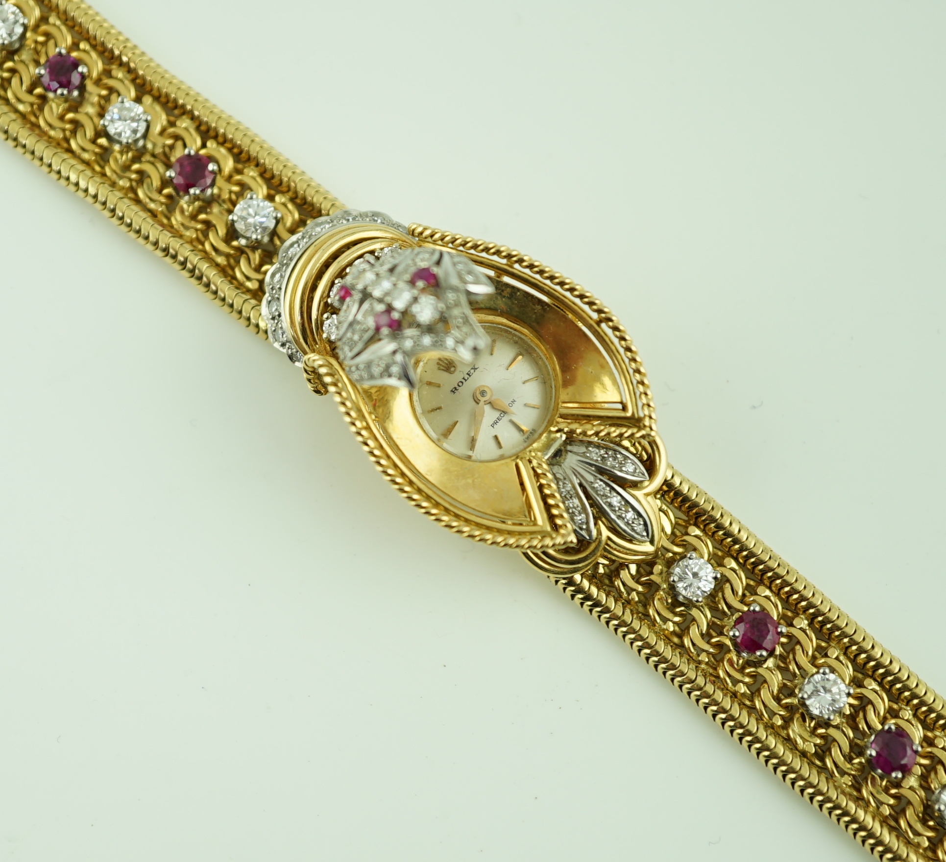 A lady's 18ct gold, ruby and diamond cluster set Rolex manual wind cocktail watch